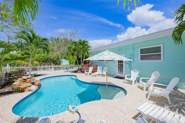 view of pool featuring a fenced in pool, a patio area, and fence