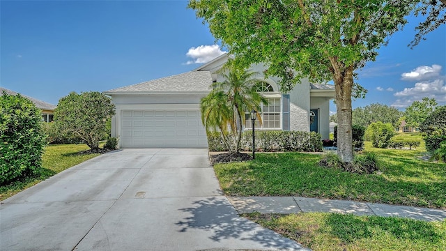 12339 Hollybush Ter, Lakewood Ranch, FL 34202 - view of front of home with an attached garage, driveway, a front lawn, and stucco siding