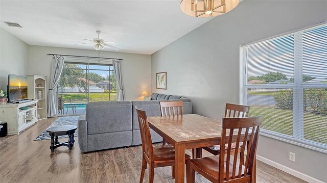 12339 Hollybush Ter, Lakewood Ranch, FL 34202 - dining space with wood finished floors, ceiling fan, and baseboards