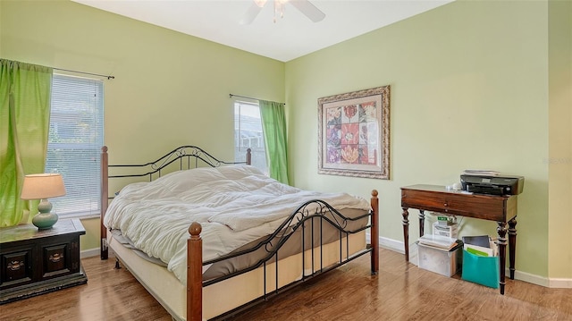 12339 Hollybush Ter, Lakewood Ranch, FL 34202 - bedroom featuring baseboards, wood finished floors, and a ceiling fan