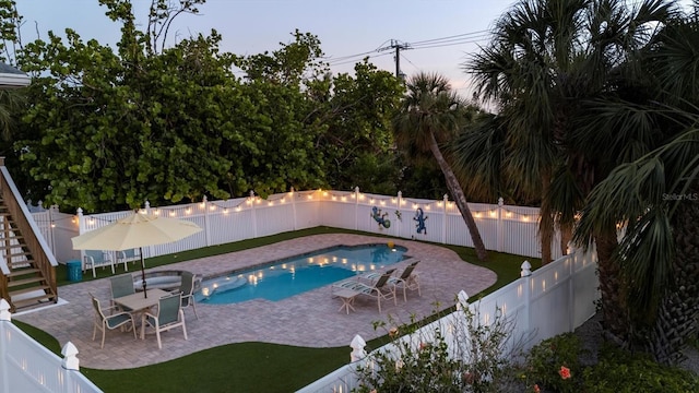 view of swimming pool featuring a patio, a fenced in pool, stairs, and a fenced backyard
