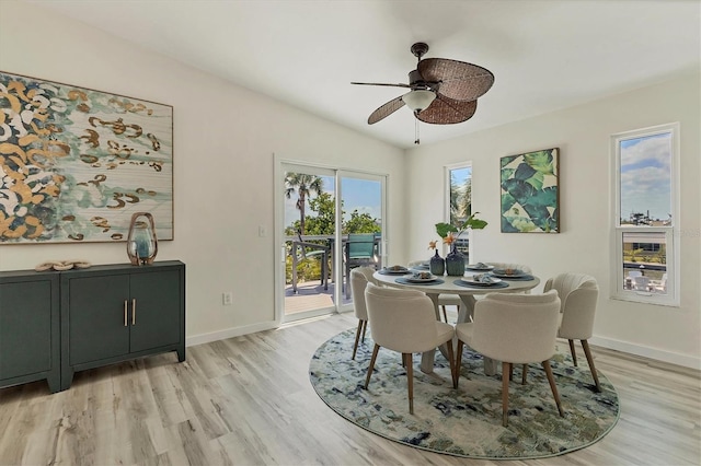 dining room with light wood-style floors, a ceiling fan, and baseboards