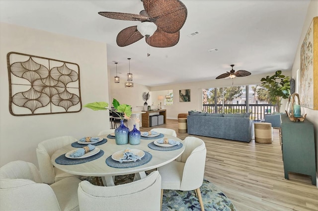 dining room with visible vents, light wood finished floors, and ceiling fan