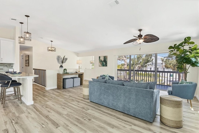 living room featuring ceiling fan, visible vents, and light wood-style floors