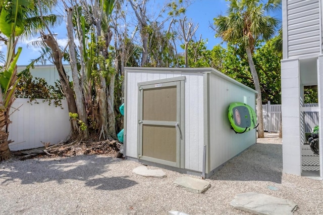 view of shed featuring fence