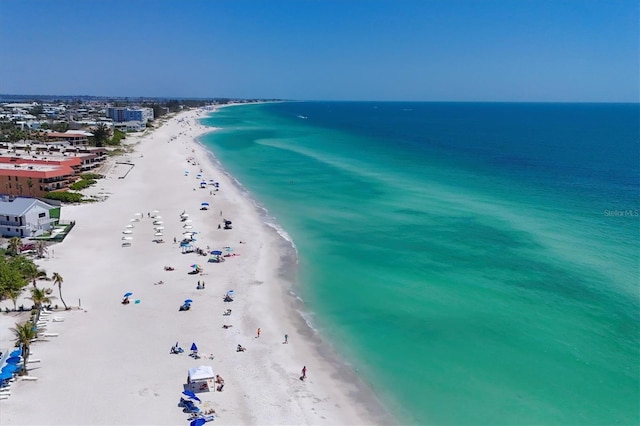 bird's eye view featuring a water view and a view of the beach