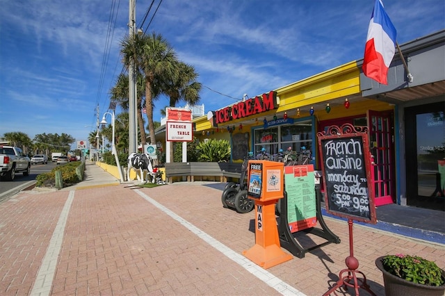 exterior space featuring street lighting, traffic signs, sidewalks, and curbs