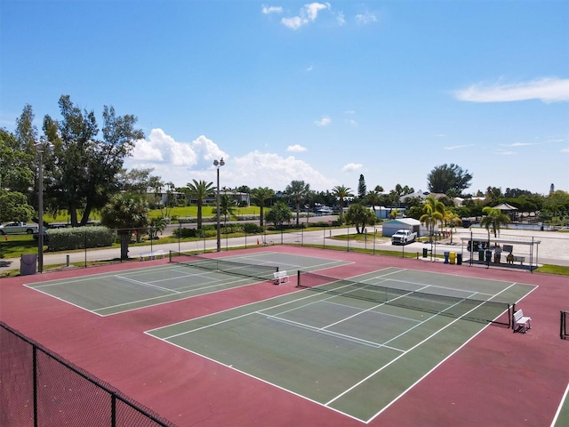 view of tennis court with fence and community basketball court