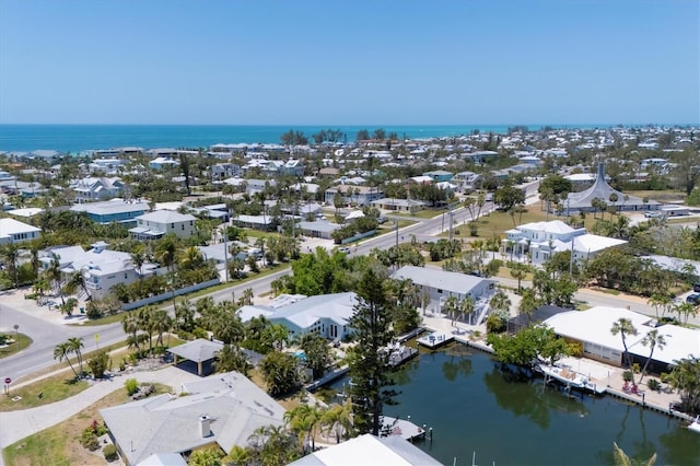 drone / aerial view featuring a residential view and a water view