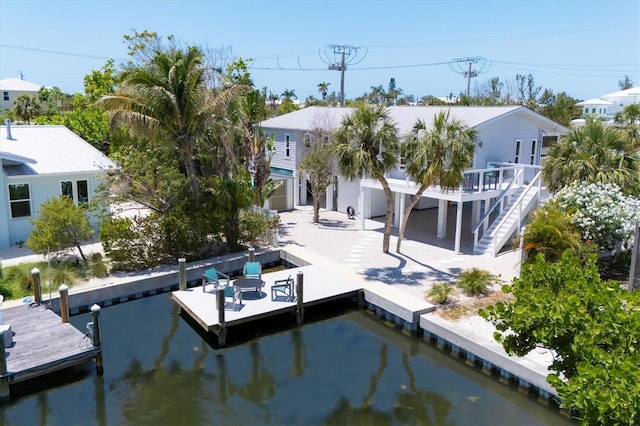 view of dock featuring stairway, a deck, and a patio area