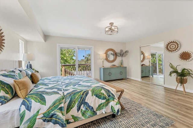 501 Key Royale Dr, Holmes Beach, FL 34217 - bedroom featuring access to outside, wood finished floors, and baseboards