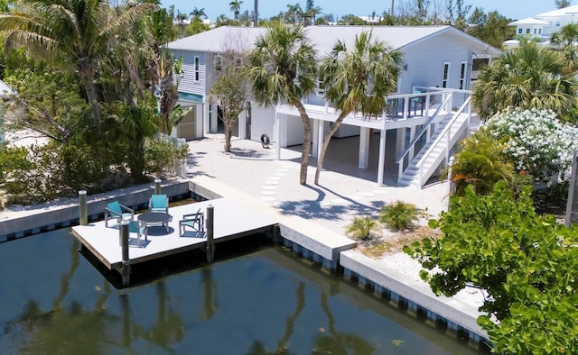 501 Key Royale Dr, Holmes Beach, FL 34217 - rear view of property with stairway and a deck with water view