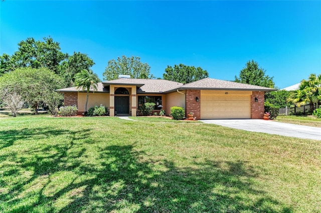 ranch-style house featuring an attached garage, fence, driveway, and a front yard