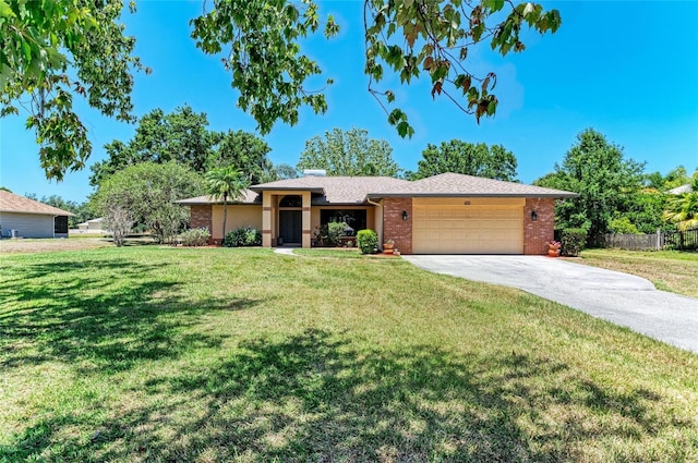 ranch-style house with fence, a front lawn, brick siding, a garage, and concrete driveway