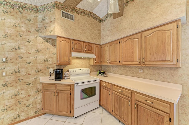kitchen featuring visible vents, light countertops, light tile patterned floors, white electric range oven, and under cabinet range hood
