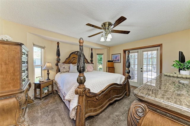 bedroom featuring access to outside, a textured ceiling, carpet floors, and french doors