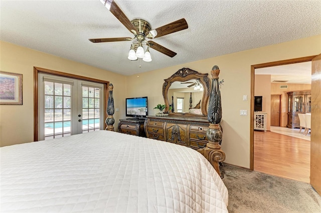 bedroom with access to exterior, ceiling fan, a textured ceiling, french doors, and carpet