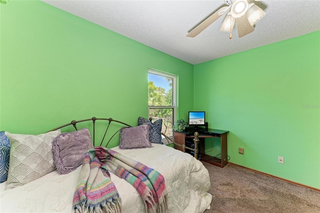carpeted bedroom with a ceiling fan and baseboards
