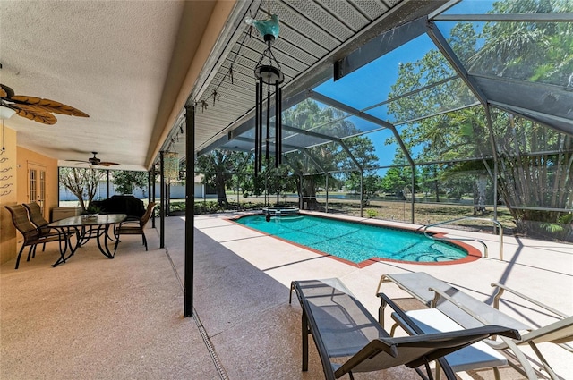 view of swimming pool featuring a patio, a lanai, ceiling fan, and a pool with connected hot tub