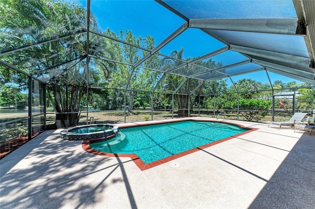 view of pool featuring a patio, a pool with connected hot tub, and glass enclosure