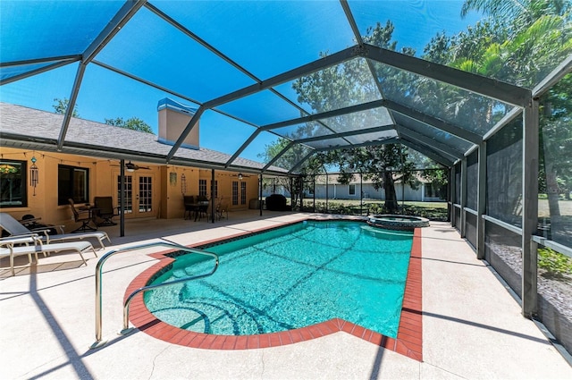 view of swimming pool with a pool with connected hot tub, ceiling fan, a patio area, french doors, and a lanai
