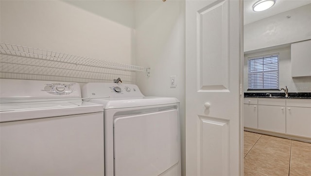 4264 Central Sarasota Pkwy Unit 111, Sarasota, FL 34238 - laundry room featuring washing machine and clothes dryer, light tile patterned flooring, and a sink