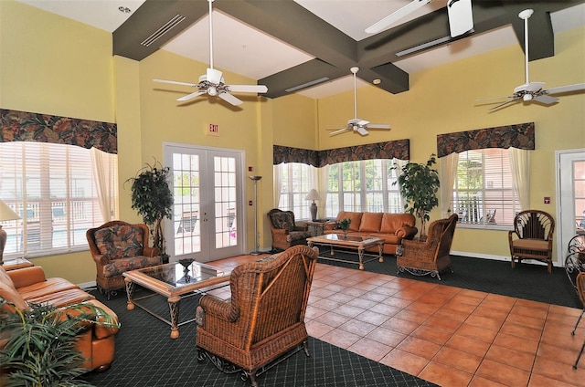 4264 Central Sarasota Pkwy Unit 111, Sarasota, FL 34238 - living room featuring a ceiling fan, tile patterned floors, a high ceiling, baseboards, and french doors