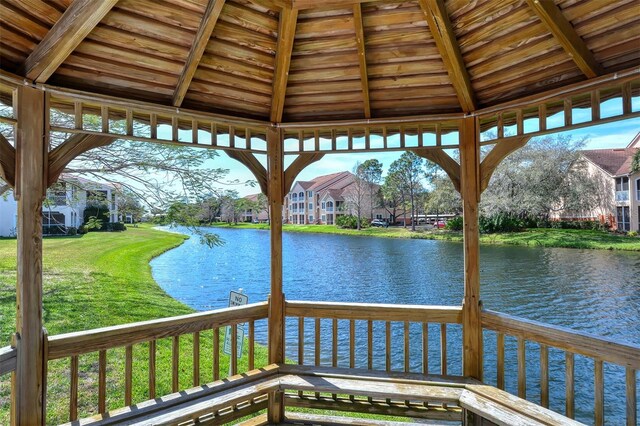 4264 Central Sarasota Pkwy Unit 111, Sarasota, FL 34238 - wooden terrace with a gazebo, a water view, a lawn, and a residential view