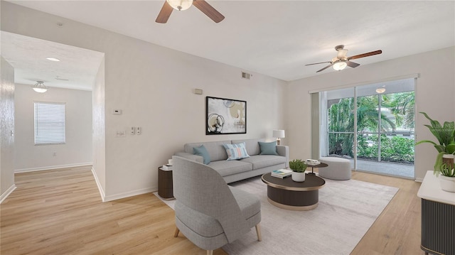 4264 Central Sarasota Pkwy Unit 111, Sarasota, FL 34238 - living room with ceiling fan, light wood finished floors, and baseboards