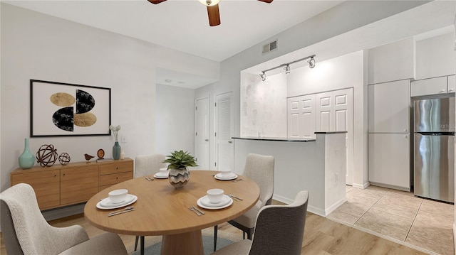 4264 Central Sarasota Pkwy Unit 111, Sarasota, FL 34238 - dining area featuring a ceiling fan, light wood-type flooring, baseboards, and rail lighting