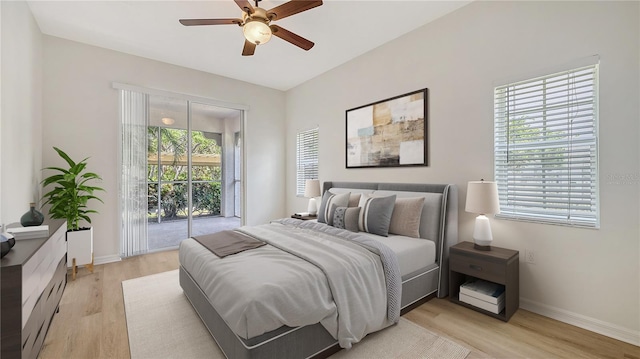 4264 Central Sarasota Pkwy Unit 111, Sarasota, FL 34238 - bedroom featuring access to outside, light wood-style floors, baseboards, and ceiling fan