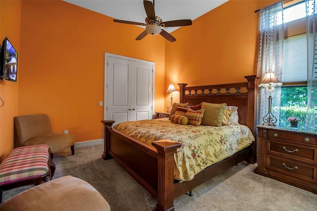 bedroom with carpet flooring, lofted ceiling, baseboards, and ceiling fan