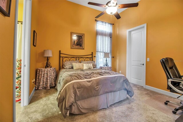 carpeted bedroom with baseboards and a ceiling fan
