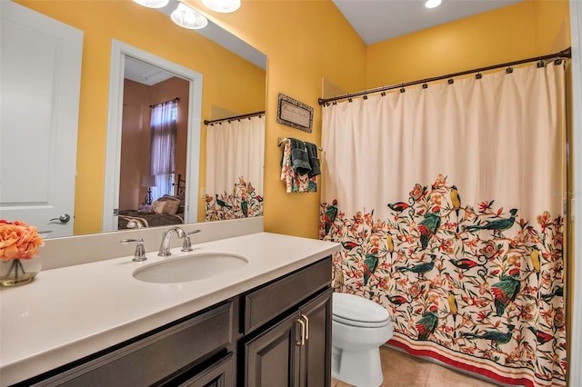 bathroom featuring tile patterned floors, vanity, and toilet