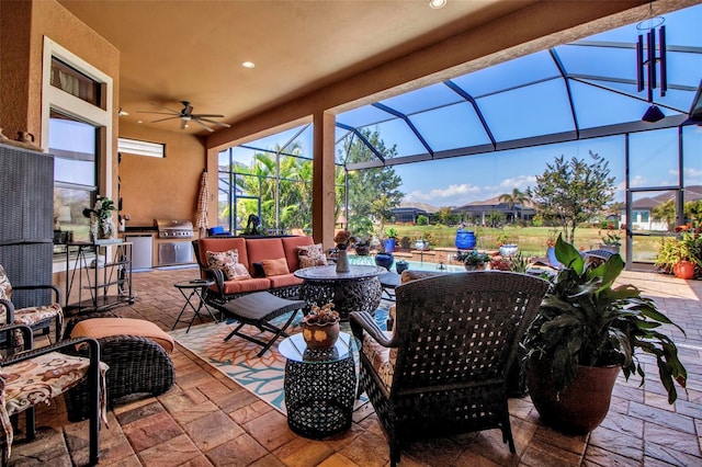 view of patio / terrace featuring an outdoor kitchen, area for grilling, glass enclosure, and an outdoor living space