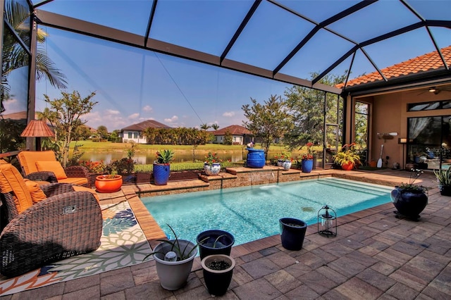 swimming pool with a patio area, glass enclosure, and a ceiling fan