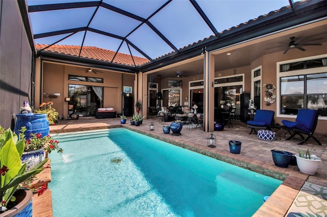 outdoor pool with ceiling fan, a patio area, and a lanai