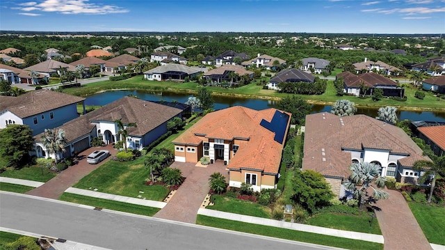 aerial perspective of suburban area with a nearby body of water