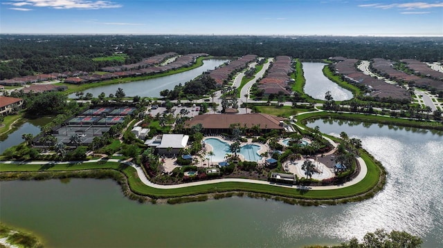 view of property location with a nearby body of water and a pool