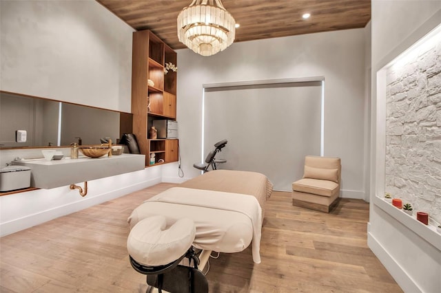 bedroom featuring a chandelier, wood finished floors, wooden ceiling, and recessed lighting