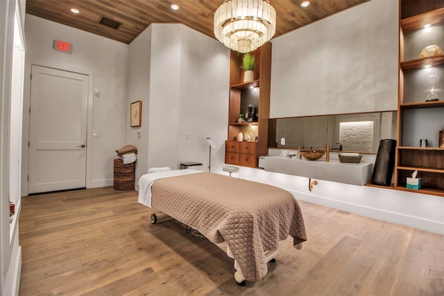 bedroom featuring wooden ceiling, wood finished floors, recessed lighting, and a chandelier