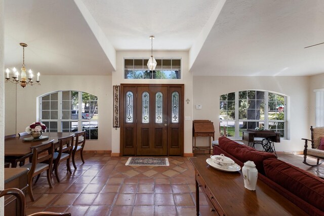 3209 2nd Ave W, Bradenton, FL 34205 - entrance foyer featuring tile patterned floors, plenty of natural light, a notable chandelier, and baseboards