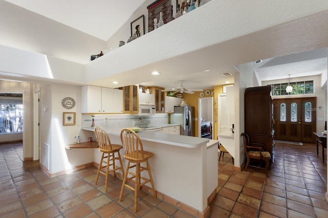 3209 2nd Ave W, Bradenton, FL 34205 - kitchen featuring a healthy amount of sunlight, white appliances, a peninsula, and ceiling fan