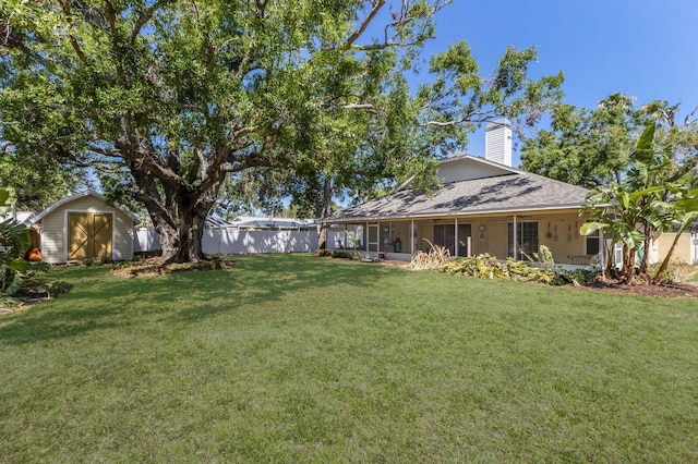 3209 2nd Ave W, Bradenton, FL 34205 - view of yard with fence, a storage unit, a sunroom, and an outdoor structure