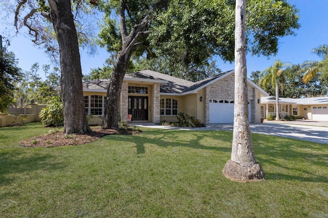 3209 2nd Ave W, Bradenton, FL 34205 - ranch-style house featuring a front yard, a garage, stone siding, concrete driveway, and stucco siding
