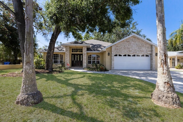 3209 2nd Ave W, Bradenton, FL 34205 - ranch-style home featuring stone siding, a front yard, concrete driveway, and an attached garage