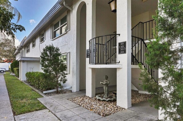 5800 Hollywood Blvd Unit 312, Sarasota, FL 34231 - view of home's exterior featuring stairway and stucco siding
