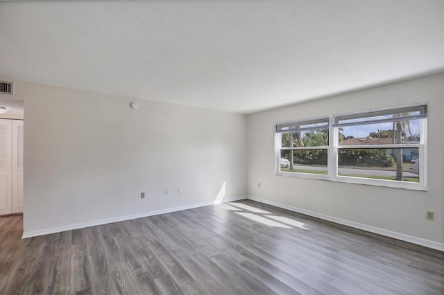 5800 Hollywood Blvd Unit 312, Sarasota, FL 34231 - unfurnished room with baseboards, visible vents, and wood finished floors