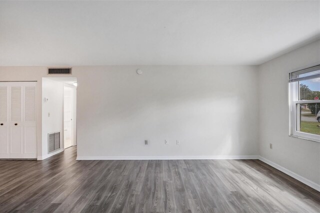 5800 Hollywood Blvd Unit 312, Sarasota, FL 34231 - spare room with baseboards, visible vents, and wood finished floors