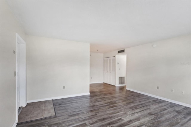 5800 Hollywood Blvd Unit 312, Sarasota, FL 34231 - spare room featuring visible vents, baseboards, and dark wood-type flooring